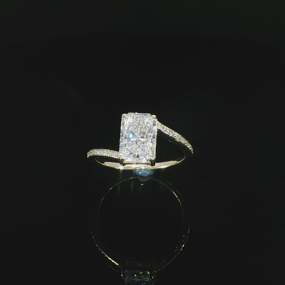 14K yellow gold radiant cut bypass engagement ring with 2 CT lab grown diamond and pavé band totaling 2.15 CTW