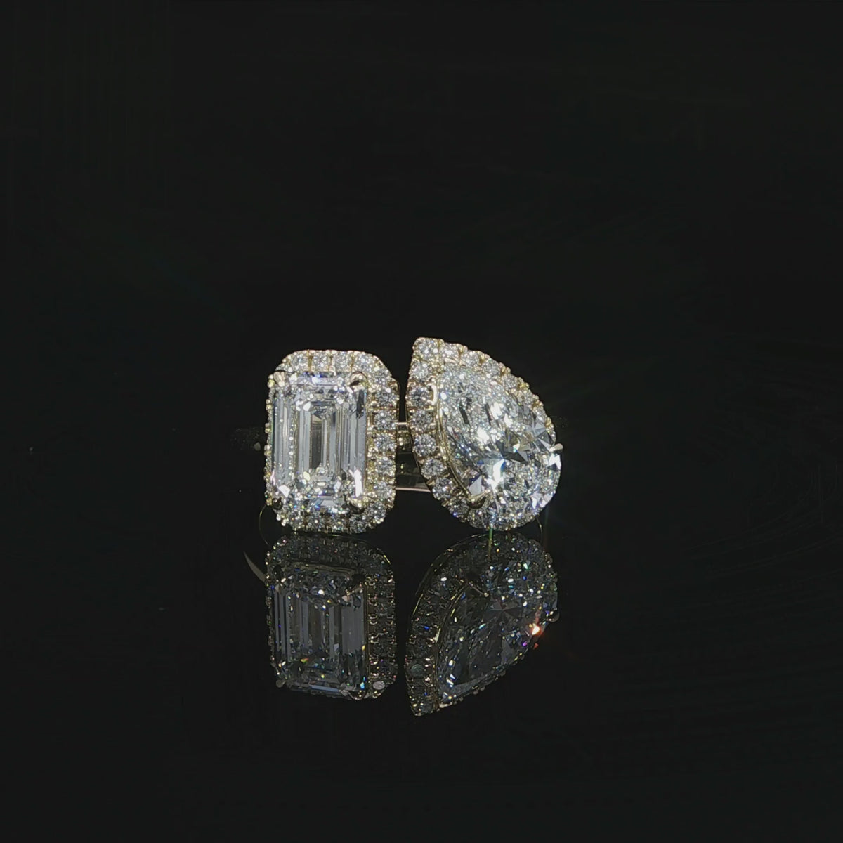 Unique open band engagement ring with emerald and pear shaped diamonds in a Toi et Moi design.