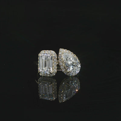 Unique open band engagement ring with emerald and pear shaped diamonds in a Toi et Moi design.