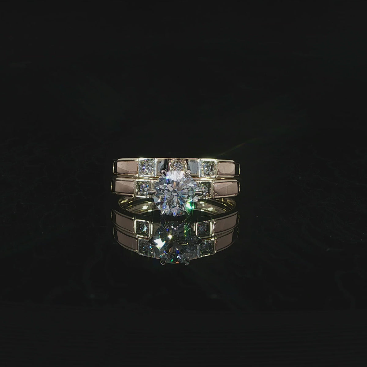 14K yellow gold bridal set with a round lab-grown diamond center, E color and VVS2 clarity, on black.