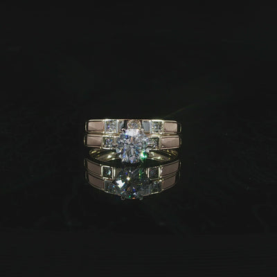 14K yellow gold bridal set with a round lab-grown diamond center, E color and VVS2 clarity, on black.