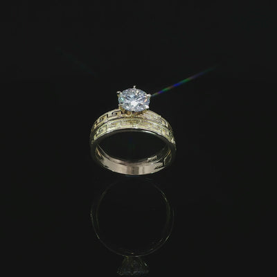 10K yellow gold ring set tilted to show the Greek key pattern, polished interiors and 1.21 CT round diamond.