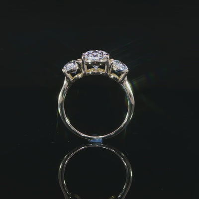 Shank view showing a larger oval center flanked by two smaller ovals in yellow gold settings.