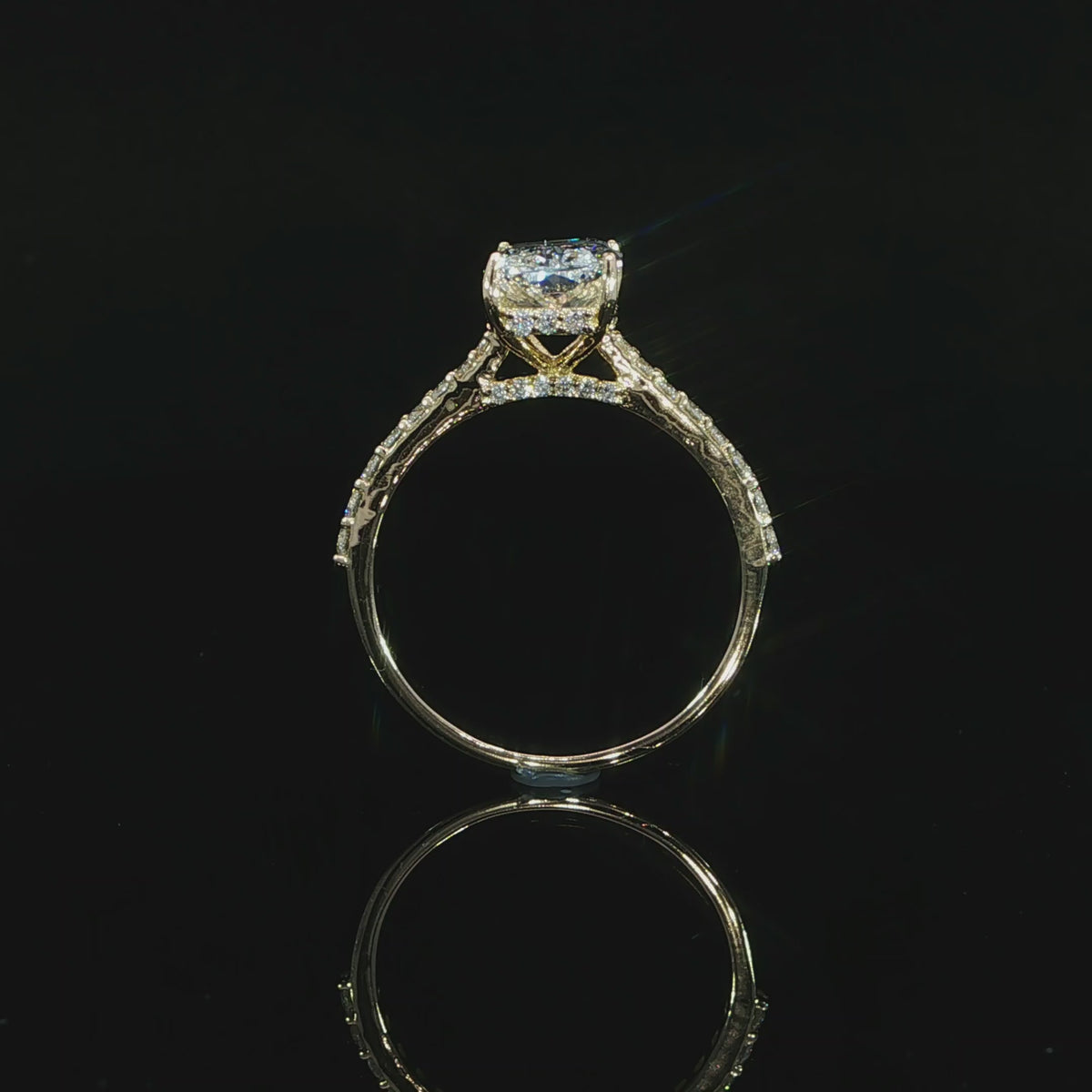 Radiant lab-grown diamond ring in yellow gold photographed against a black background