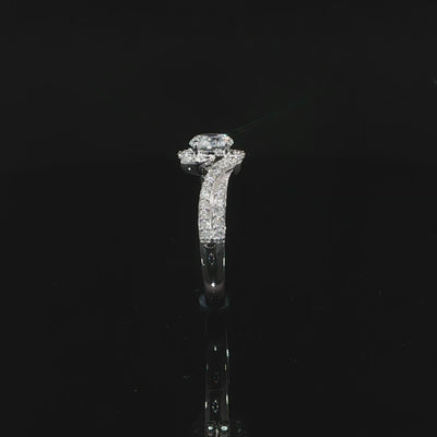 Video of a round center diamond framed by curved pavé bypass bands in white gold.
