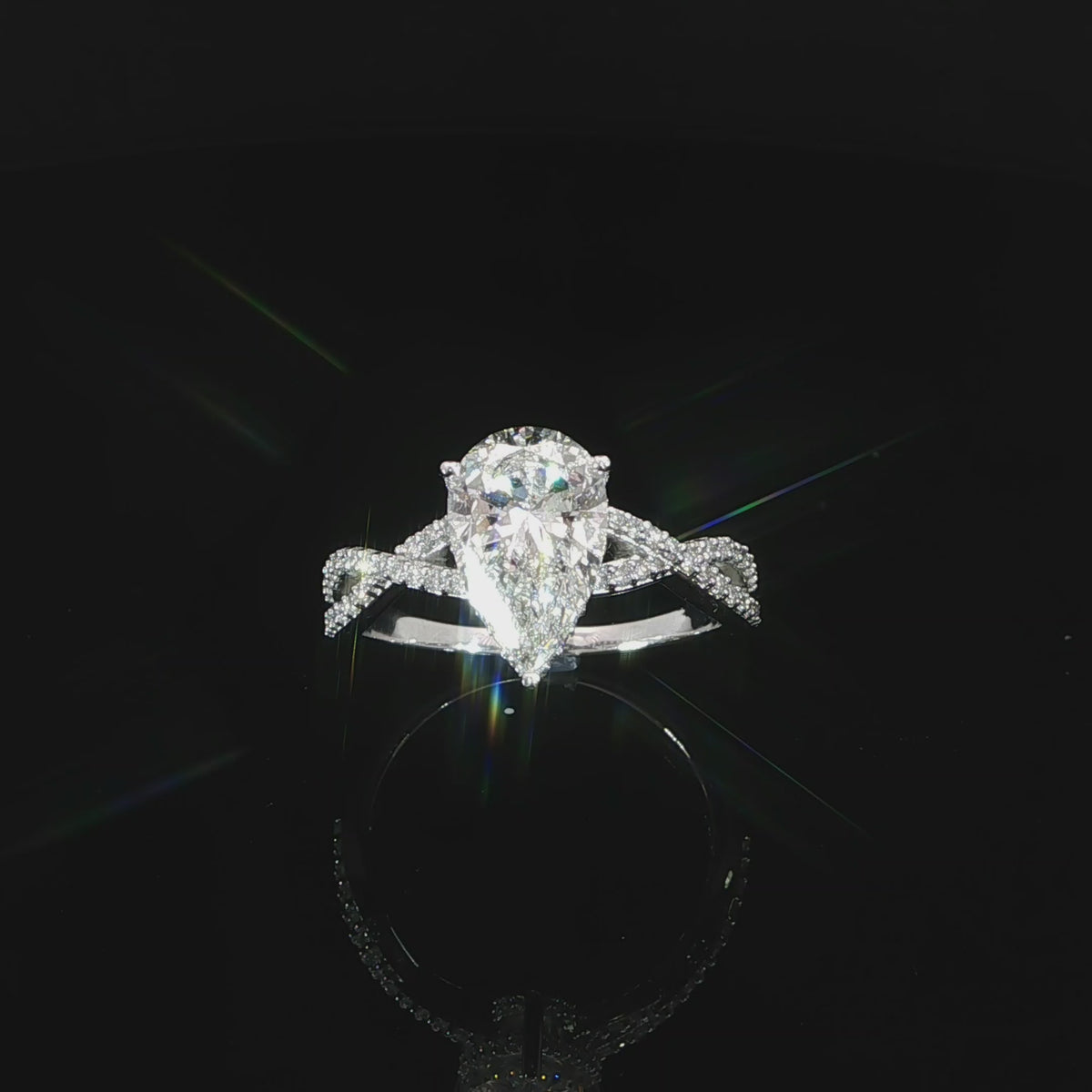 Engagement ring featuring an E color, VS1 clarity pear-shaped lab-grown diamond with a hidden halo.