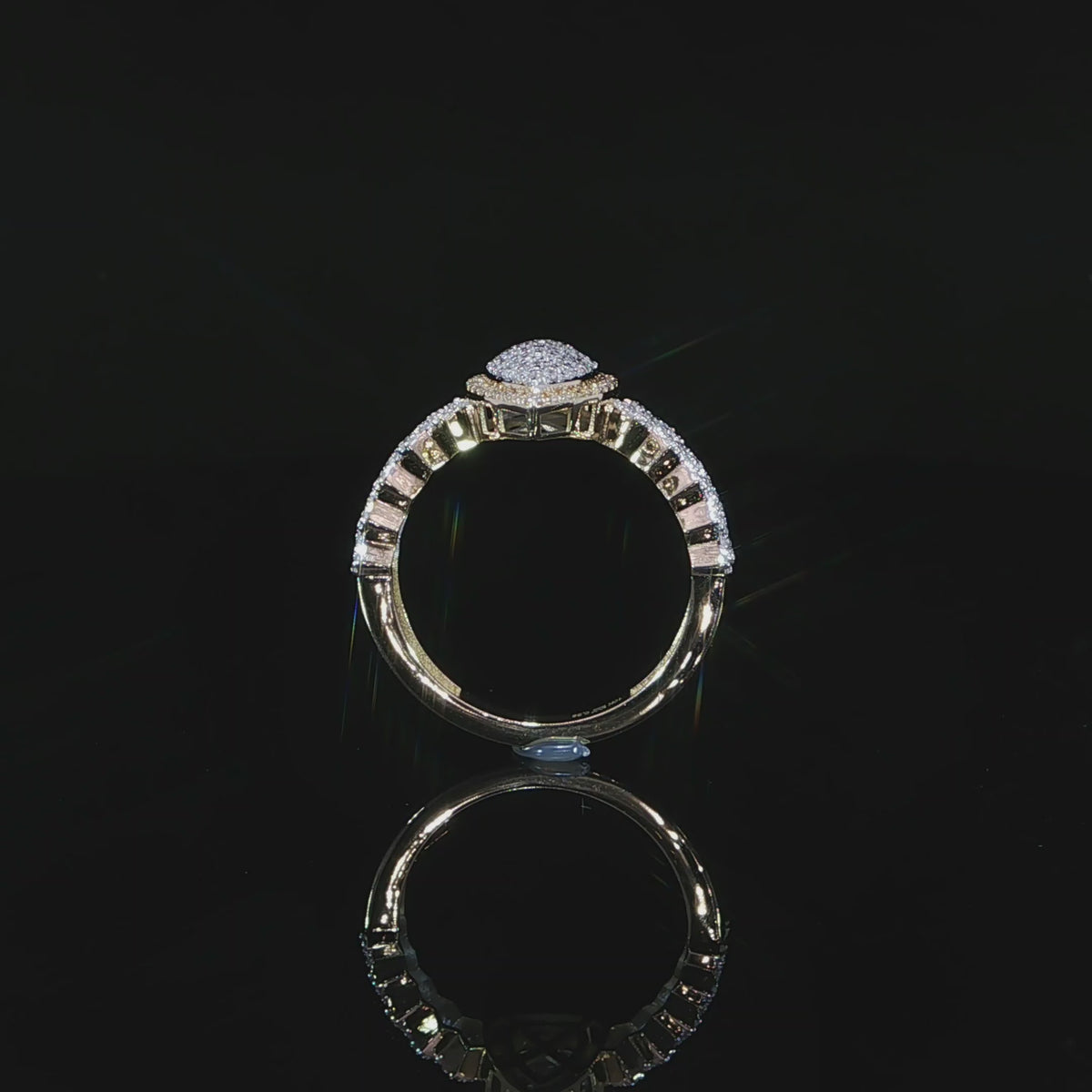 Upright side view of a 10K yellow gold 0.38 CTW pear halo ring showing the raised setting and diamond shoulders.