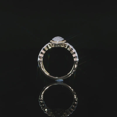 Upright side view of a 10K yellow gold 0.38 CTW pear halo ring showing the raised setting and diamond shoulders.
