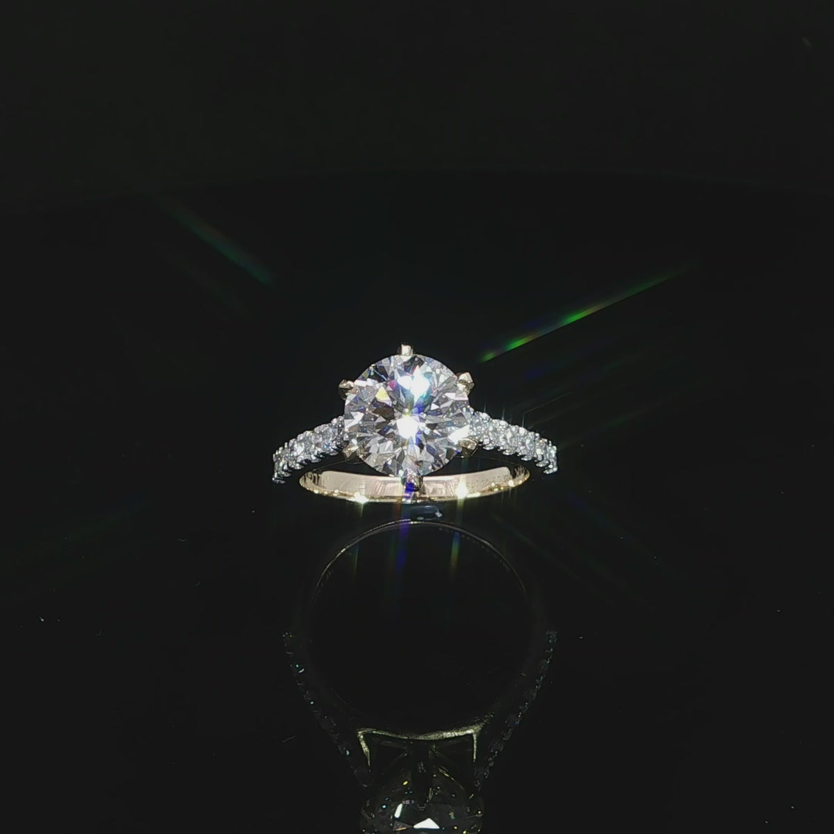 Round lab grown diamond engagement ring with a pavé diamond band in polished 14K yellow gold.