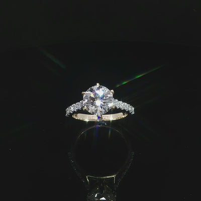 Round lab grown diamond engagement ring with a pavé diamond band in polished 14K yellow gold.