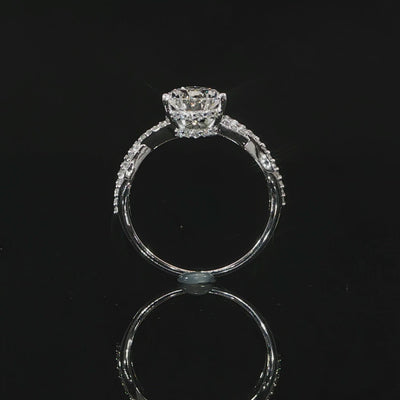 Close view video of the intertwined diamond-accented band supporting the pear-shaped center stone.