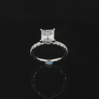 Top view of 2 carat princess cut solitaire engagement ring with pave diamond band.