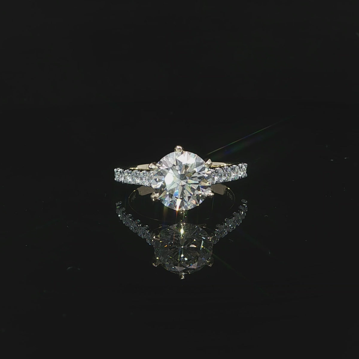 14K yellow gold engagement ring with a 2.54 carat round lab grown diamond in a six-prong cathedral setting.