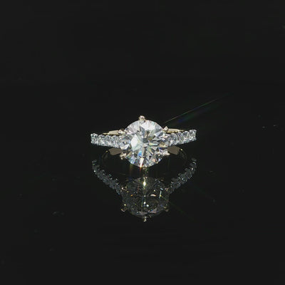 14K yellow gold engagement ring with a 2.54 carat round lab grown diamond in a six-prong cathedral setting.