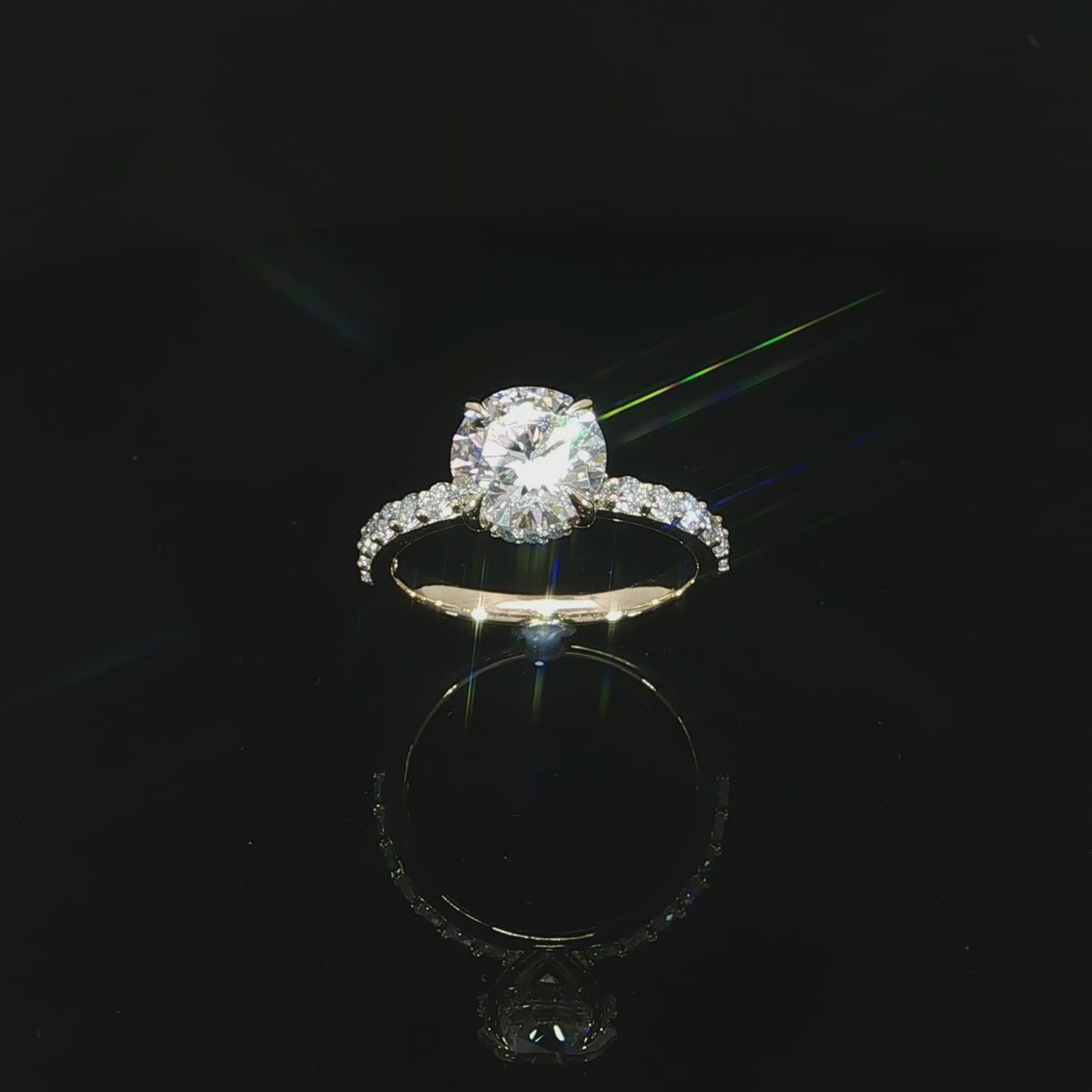 Angled view of a 14K yellow gold engagement ring with a 2.10-carat round center diamond.