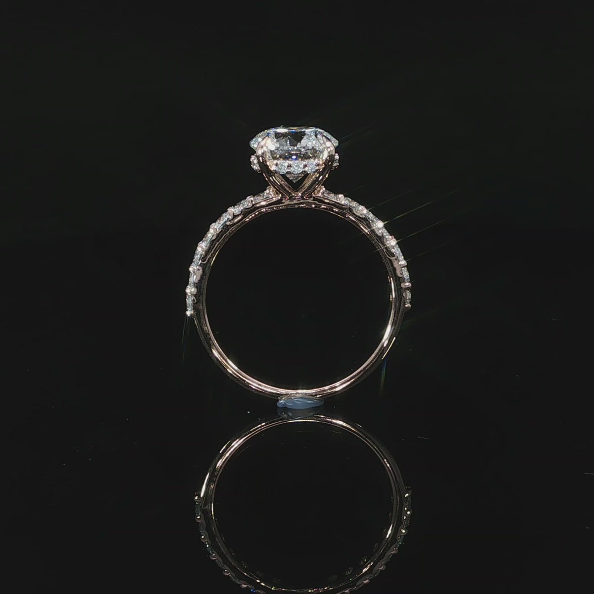 Side profile video of 14k rose gold with hidden halo and diamonds on the band.