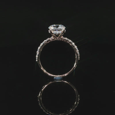 Side profile video of 14k rose gold with hidden halo and diamonds on the band.