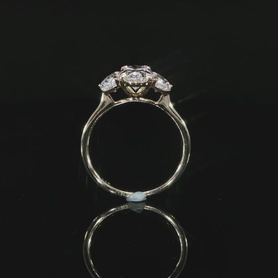 Video of the three-stone setting crafted on a polished 14K yellow gold band.