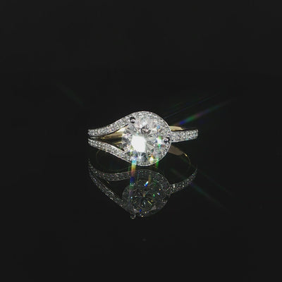 Detailed video of a round center diamond framed by split pavé bypass bands in 14K yellow gold.