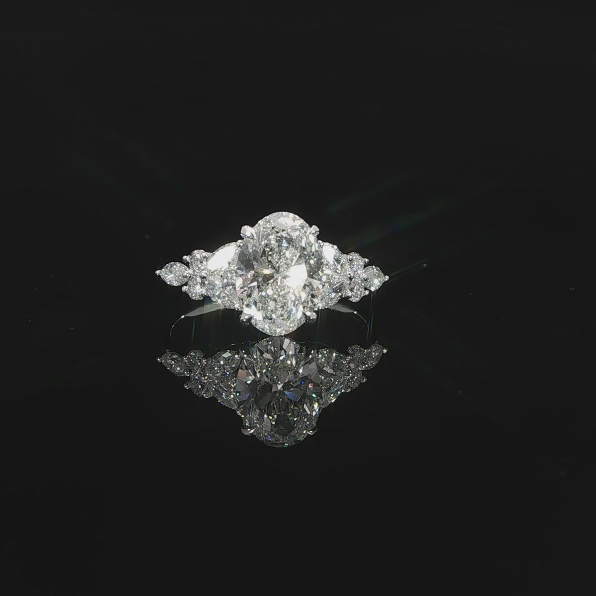 14K white gold engagement ring with a 2 carat E color VS1 oval lab grown diamond and diamond side accents.