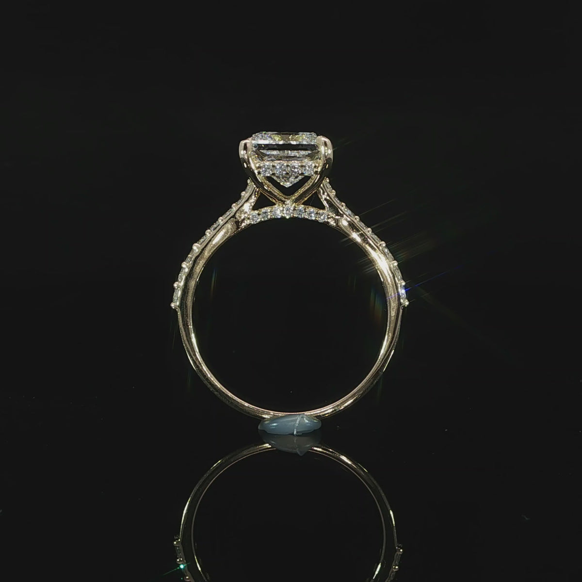Profile view of a princess cut engagement ring showing the hidden halo, cathedral shoulders, and elevated center setting.
