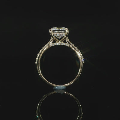 Profile view of a princess cut engagement ring showing the hidden halo, cathedral shoulders, and elevated center setting.