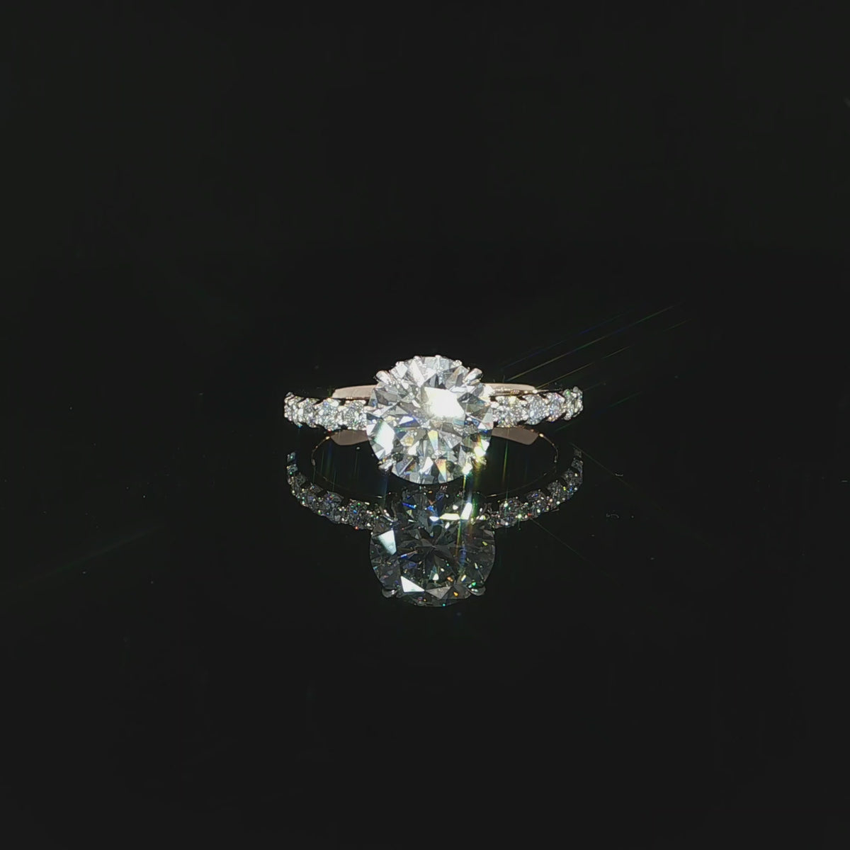 Modern round solitaire-style engagement ring with a hidden halo and diamond-accented rose gold band.