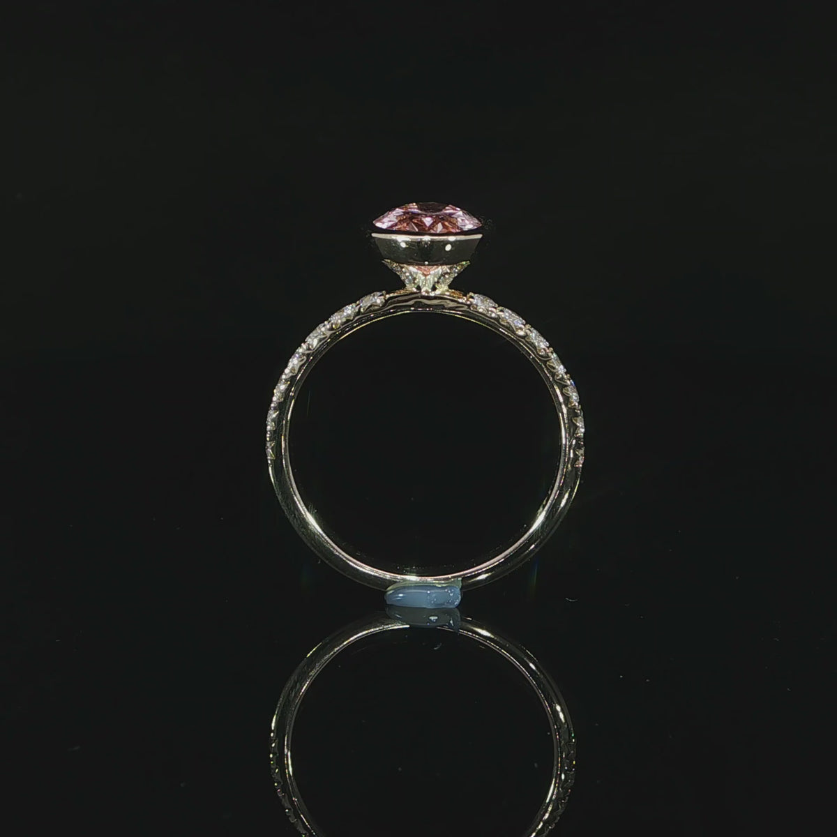 14k yellow gold fancy vivid pink oval diamond with a hidden halo and pave diamond band