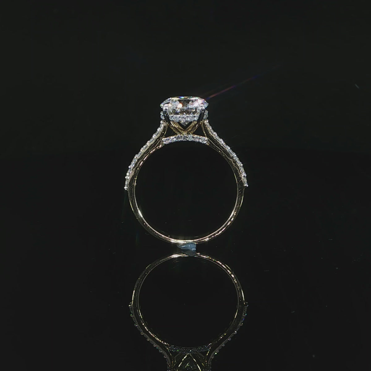 Close view of the diamond-accented cathedral shoulders rising toward the center setting.