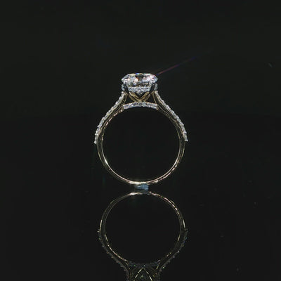 Close view of the diamond-accented cathedral shoulders rising toward the center setting.