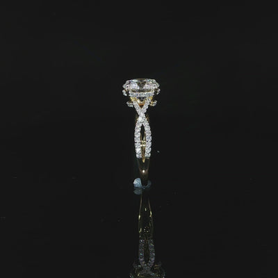 Close view of the intertwined diamond-accented band crafted in polished yellow gold.