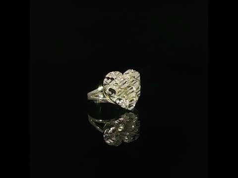 Polished gold shapes and textured recesses across the heart-shaped face of a yellow gold ring.