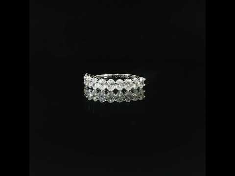 Oval cut lab-grown diamonds in prong settings across the front of a 14K white gold half eternity band.