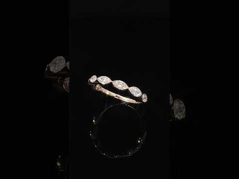 Tilted view of a 14K rose gold ring with lab-grown marquise diamonds and a polished inner shank.