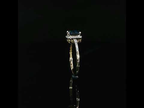 Upright profile of a 7 × 5 mm natural blue topaz ring in 14K yellow gold with 0.09 CTW diamonds.