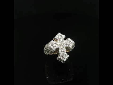 Three-quarter view highlighting the round diamond shoulders and baguette-set cross face.