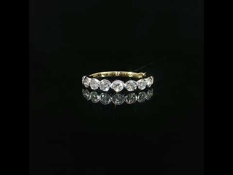 Modern 14K yellow gold diamond wedding ring featuring 0.87 total carats of round bezel set lab grown diamonds.