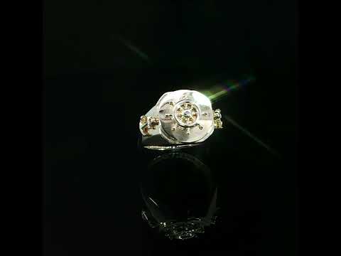 Angled view of a yellow gold nautical signet ring with a raised ship wheel, anchor detail and polished band.