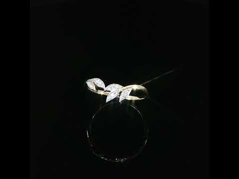 Angled side view of a 14K yellow gold leaf ring showing its smooth shank and pointed diamond-set leaves.