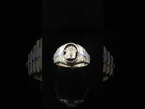 Angled view of a 14K two-tone gold Jesus ring displaying alternating yellow and white-tone metal accents with symmetrical stepped detailing along the shoulders.