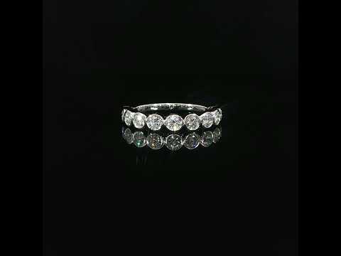 White gold bezel-set band featuring 0.87 CTW of round lab-grown diamonds on a reflective black surface.