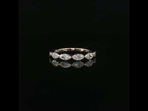 Front view of a rose gold marquise bezel band with its reflection beneath it against a black background.