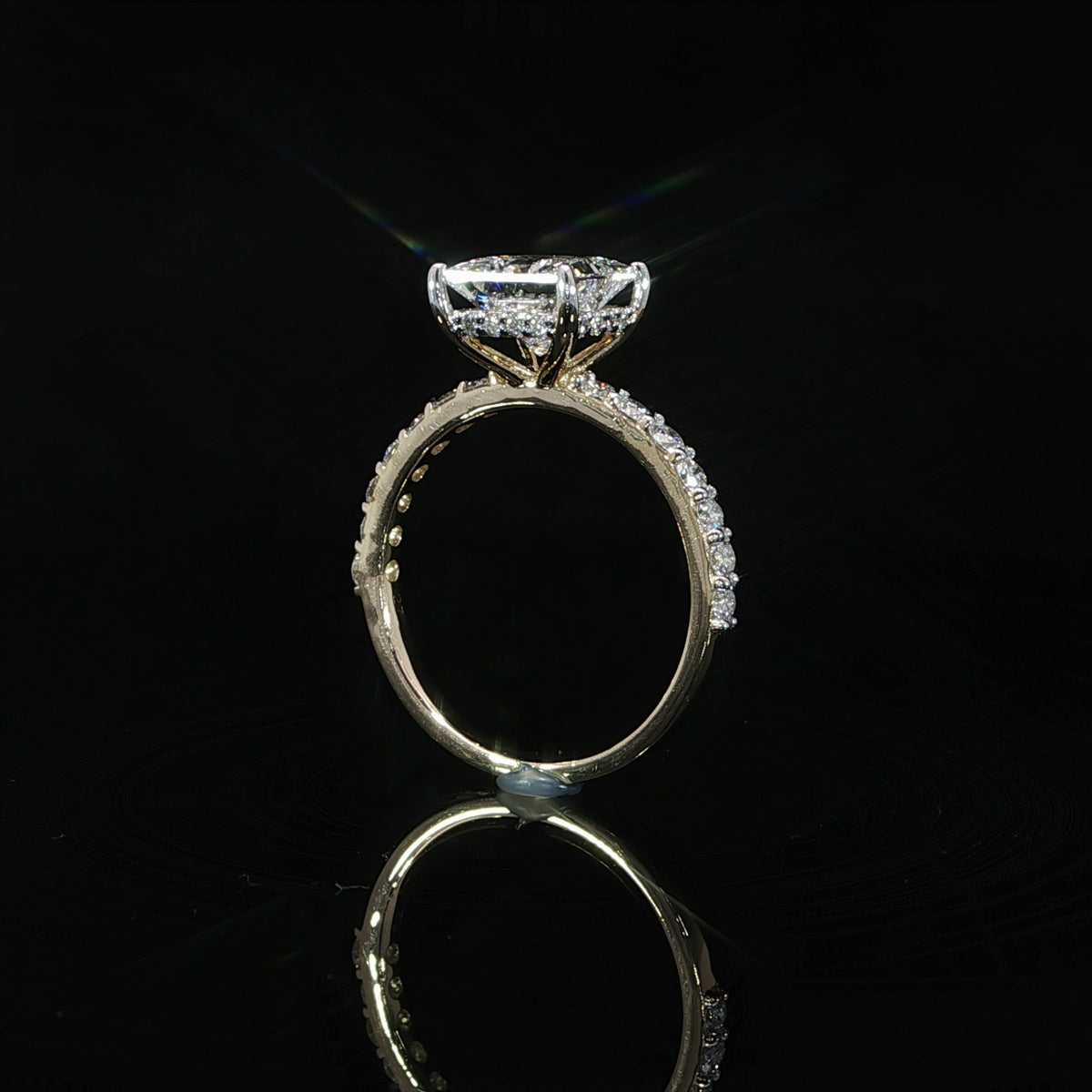 Gallery view of a princess cut diamond engagement ring highlighting the hidden halo beneath the center stone.