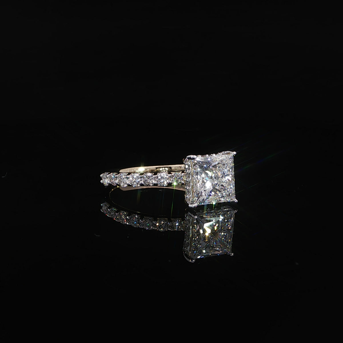 Princess cut solitaire engagement ring in 14K yellow gold with pavé diamond accents and a hidden halo.