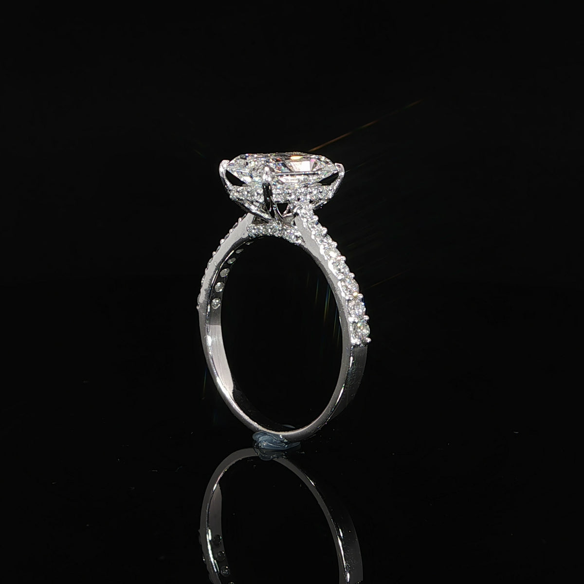 Close-up of the diamond hidden halo beneath the radiant-cut center stone.
