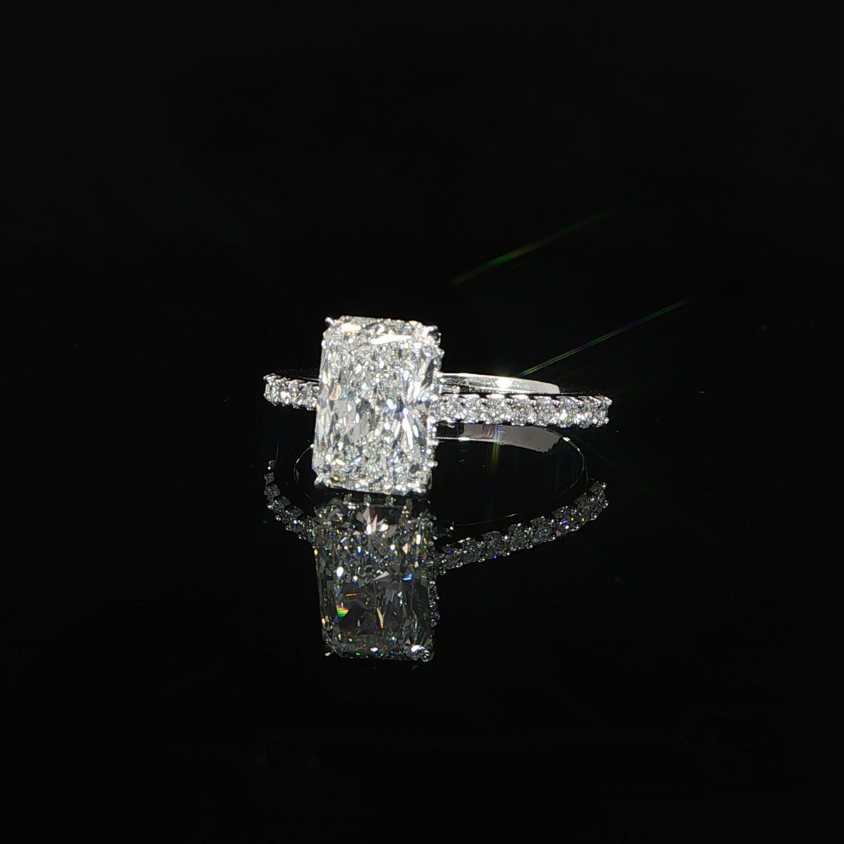 Front view of the 2.08 CT radiant diamond and pavé-set white gold band.