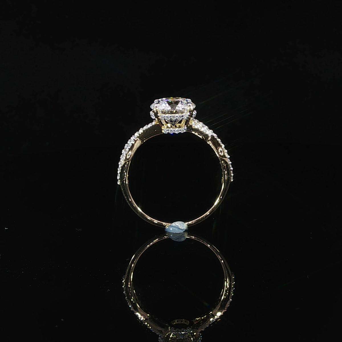 Detailed view of the hidden halo encircling the base of the 2.04-carat round center diamond.