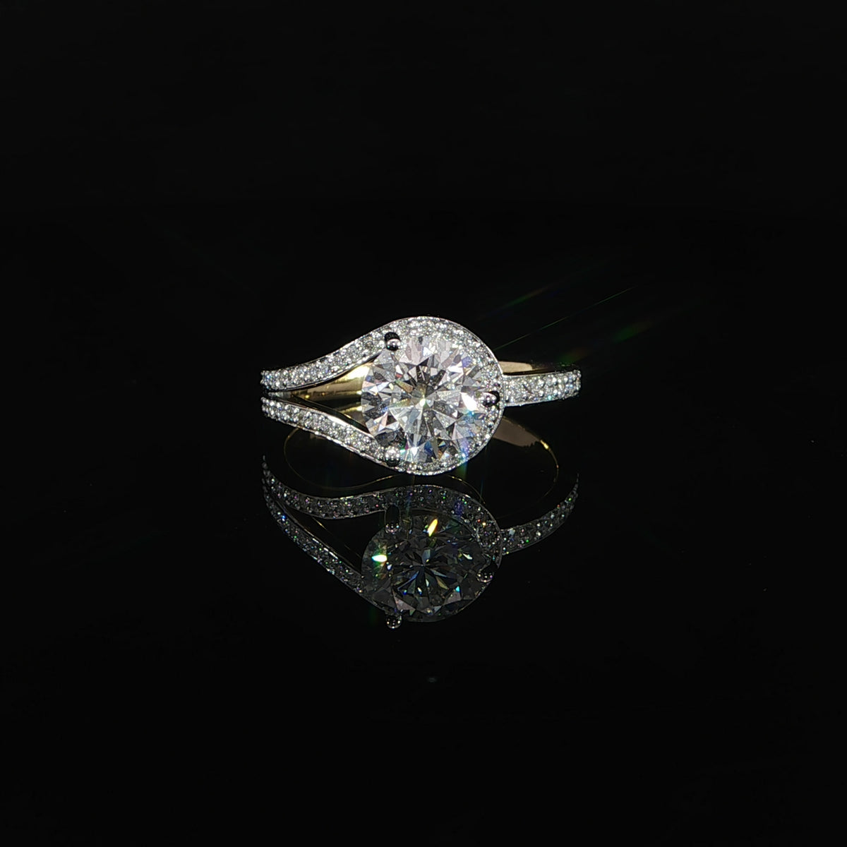 Front view of a round diamond bypass engagement ring in 14K yellow gold with sweeping pavé diamond bands.