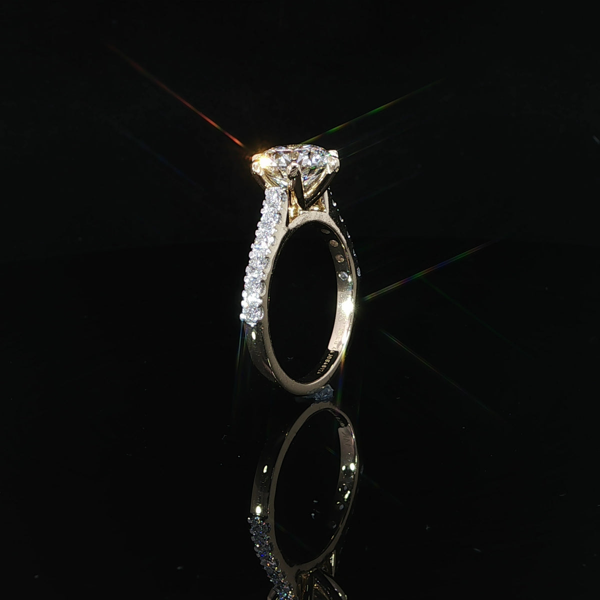 Detailed view of a round diamond engagement ring with a secure six-prong setting in yellow gold