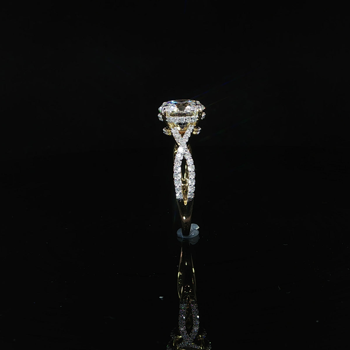 Side profile showing the hidden diamond halo beneath the round lab-grown center stone.